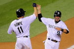 DENVER - AUGUST 25:   Ian Stewart #9 of the Colorado Rockies is greeted by Brad Hawpe #11 as he scores the game-winning run on a Troy Tulowitzki RBI single in the 10th inning against the Los Angeles Dodgers at Coors Field on August 25, 2009 in Denver, Colorado. The Rockies defeated the Dodgers 5-4 in 10 innings.  (Photo by Doug Pensinger/Getty Images)