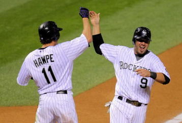 DENVER - AUGUST 25:   Ian Stewart #9 of the Colorado Rockies is greeted by Brad Hawpe #11 as he scores the game-winning run on a Troy Tulowitzki RBI single in the 10th inning against the Los Angeles Dodgers at Coors Field on August 25, 2009 in Denver, Colorado. The Rockies defeated the Dodgers 5-4 in 10 innings.  (Photo by Doug Pensinger/Getty Images)