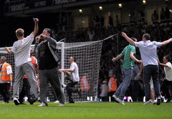 LONDON, ENGLAND - AUGUST 25:  Fans invade the pitch during the Carling Cup second round match between West Ham United and Millwall at Upton Park on August 25, 2009 in London, England.  . Violence broke out between West Ham and Millwall supporters, prior to kick off in tonight's second round Carling Cup at Upton Park. According to reports bricks and bottles were being used as missiles as fans broke through a riot police divide  (Photo by Shaun Botterill/Getty Images)