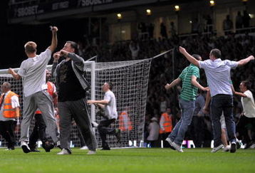 LONDON, ENGLAND - AUGUST 25:  Fans invade the pitch during the Carling Cup second round match between West Ham United and Millwall at Upton Park on August 25, 2009 in London, England.  . Violence broke out between West Ham and Millwall supporters, prior to kick off in tonight's second round Carling Cup at Upton Park. According to reports bricks and bottles were being used as missiles as fans broke through a riot police divide  (Photo by Shaun Botterill/Getty Images)