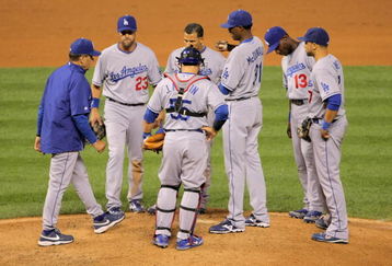 DENVER - AUGUST 25:  Manager Joe Torre #6 of the Los Angeles Dodgers goes to the mound to talk to pitcher James McDonald #31 and the infield after the bases were loaded in the 10th inning at Coors Field on August 25, 2009 in Denver, Colorado. Troy Tulowitzki got a game-winning RBI as the Rockies defeated the Dodgers 5-4 in 10 innings.  (Photo by Doug Pensinger/Getty Images)