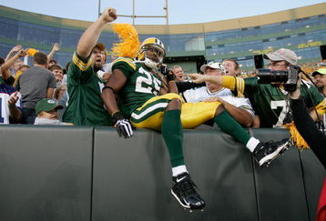GREEN BAY, WI - AUGUST 22: Running back Ryan Grant #25 of the Green Bay Packers jumps in the stands to celebrate with fans after scoring a touchdown against the Buffalo Bills at Lambeau Field on August 22, 2009 in Green Bay. Wisconsin.  (Photo by Scott Boehm/Getty Images)
