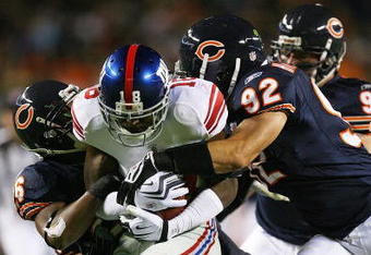 CHICAGO - AUGUST 22: Hakeem Nicks #18 of the New York Giants is tackled by Josh Bullocks #36 and Hunter Hillenmeyer #92 of the Chicago Bears during a pre-season game on August 22, 2009 at Soldier Field in Chicago, Illinois. The Bears defeated the Giants 17-3. (Photo by Jonathan Daniel/Getty Images)