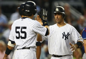 NEW YORK - AUGUST 26: Jorge Posada #20 of the New York Yankees celebrates his three run homer with team mate Hideki Matsui #55 in the second inning against the Texas Rangers during their game on August 26, 2009 at Yankee Stadium in the Bronx borough of New York City.  (Photo by Chris McGrath/Getty Images)