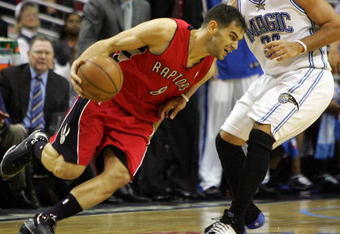 ORLANDO, FL - APRIL 22:  Jose Calderon #8 of the Toronto Raptors drives against Carlos Arroyo #30 of the Orlando Magic in Game Two of the Eastern Conference Quarterfinals during the 2008 NBA Playoffs at Amway Arena April 22, 2008 in Orlando Florida. NOTE TO USER: User expressly acknowledges and agrees that, by downloading and or using this Photograph, user is consenting to the terms and conditions of the Getty Images License Agreement.  (Photo by Sam Greenwood/Getty Images)