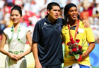 BEIJING - AUGUST 23: Juan Riquelme of Argentina and Ronaldinho of Brazil share a joke during the medal ceremony for the Men's Final between Nigeria and Argentina at the National Stadium on Day 15 of the Beijing 2008 Olympic Games on August 23, 2008 in Beijing, China.  (Photo by Koji Watanabe/Getty Images)