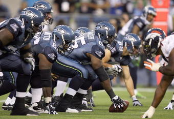 SEATTLE - AUGUST 22:  Center Chris Spencer #65 of the Seattle Seahawks gets ready to hike the ball during the game against the Denver Broncos on August 22, 2009 at Qwest Field in Seattle, Washington. (Photo by Otto Greule Jr/Getty Images)  