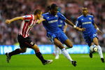 SUNDERLAND, ENGLAND - AUGUST 18:  Phil Bardsley of Sunderland challenges Didier Drogba of Chelsea during the Barclays Premier League match between Sunderland and Chelsea at the Stadium of Light on August 18, 2009 in Manchester, England. (Photo by Michael Regan/Getty Images)