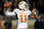 LUBBOCK, TX - NOVEMBER 08:  Quarterback Zac Robinson #11 of the Oklahoma State Cowboys drops back to pass against the Texas Tech Red Raiders at Jones AT&T Stadium on November 8, 2008 in Lubbock, Texas.  (Photo by Ronald Martinez/Getty Images)