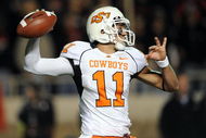 LUBBOCK, TX - NOVEMBER 08:  Quarterback Zac Robinson #11 of the Oklahoma State Cowboys drops back to pass against the Texas Tech Red Raiders at Jones AT&T Stadium on November 8, 2008 in Lubbock, Texas.  (Photo by Ronald Martinez/Getty Images)