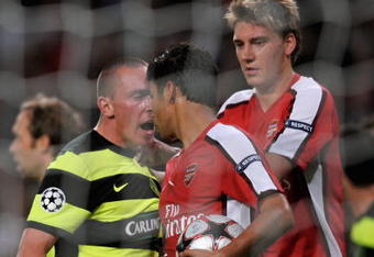 LONDON, ENGLAND - AUGUST 26:  Eduardo of Arsenal is confronted by Scott Brown of Celtic after winning a first half penalty for his team during the UEFA Champions League 2nd qualifying round 2nd leg match between Arsenal and Celtic at the Emirates Stadium on August 26, 2009 in London, England.  (Photo by Shaun Botterill/Getty Images)