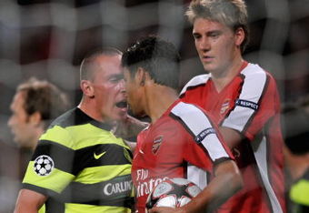 LONDON, ENGLAND - AUGUST 26:  Eduardo of Arsenal is confronted by Scott Brown of Celtic after winning a first half penalty for his team during the UEFA Champions League 2nd qualifying round 2nd leg match between Arsenal and Celtic at the Emirates Stadium on August 26, 2009 in London, England.  (Photo by Shaun Botterill/Getty Images)