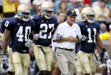 SOUTH BEND, IN - SEPTEMBER 13:  Former head coach Lou Holtz of the Notre Dame Fighting Irish walks out for the coin toss with David Grimes #11, David Bruton #27 and Maurice Crum #40 prior to playing the Michigan Wolverines on September 13, 2008 at Notre Dame Stadium in South Bend, Indiana.  (Photo by Gregory Shamus/Getty Images)
