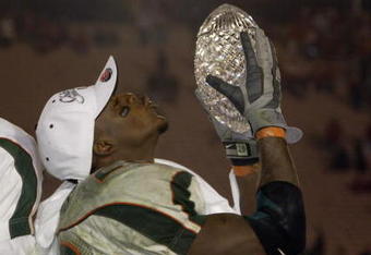 3 Jan 2002:  Clinton Portis #28 of Miami lifts the Sears National Championship trophy as quarterback Ken Dorsey #11 looks on after the win over Nebraska in the Rose Bowl National Championship game at the Rose Bowl in Pasadena, California.  Miami won the game 37-14, winning the BCS and the National Championship title. DIGITAL IMAGE. Mandatory Credit: Brian Bahr/Getty Images