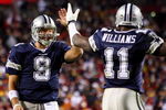 LANDOVER, MD - NOVEMBER 16:  Tony Romo #9 of the Dallas Cowboys celebrates his teams first touchdown against the Washington Redskins with teammate Roy Williams #11 on November 16, 2008 at FedEx Field in Landover, Maryland.  (Photo by Jim McIsaac/Getty Images)