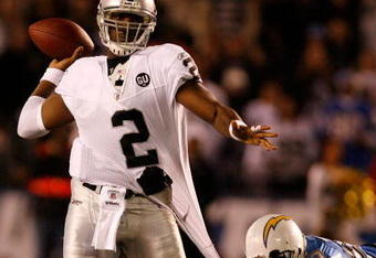 SAN DIEGO - DECEMBER 04:  Quarterback JaMarcus Russell #2 of the Oakland Raiders is grabbed by Linebacker Shaun Philips #95 of the San Diego Chargers during their NFL Game on December 4, 2008 at Qualcomm Stadium in San Diego, California.  (Photo by Harry How/Getty Images)