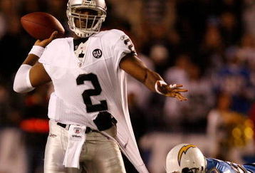 SAN DIEGO - DECEMBER 04:  Quarterback JaMarcus Russell #2 of the Oakland Raiders is grabbed by Linebacker Shaun Philips #95 of the San Diego Chargers during their NFL Game on December 4, 2008 at Qualcomm Stadium in San Diego, California.  (Photo by Harry How/Getty Images)
