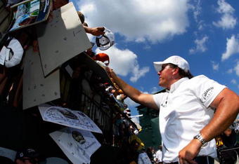 CHASKA, MN - AUGUST 12:  Phil Mickelson signs autographs for fans during the third preview day of the 91st PGA Championship at Hazeltine National Golf Club on August 12, 2009 in Chaska, Minnesota.  (Photo by Jamie Squire/Getty Images)