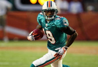 MIAMI - AUGUST 17:  Wide receiver Ted Ginn Jr. #19 of the Miami Dolphins looks for room to run against the Jacksonville Jaguars during a preseason game at Landshark Stadium on August 17, 2009 in Miami, Florida.  (Photo by Doug Benc/Getty Images)