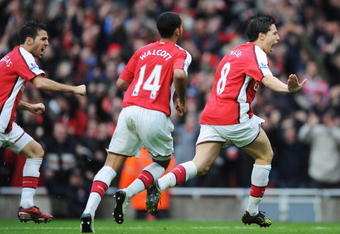 LONDON - NOVEMBER 08:  Samir Nasri of Arsenal (R) celebrates with Theo Walcott and Francesc Fabregas as he scores their second goal during the Barclays Premier League match between Arsenal and Manchester United at the Emirates Stadium on November 8, 2008 in London, England.  (Photo by Shaun Botterill/Getty Images)