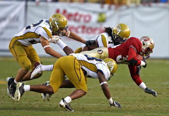 ATLANTA - NOVEMBER 1:  Members of the Georgia Tech Yellow Jackets defense, including safety Morgan Burnett #1, swarm running back Jermaine Thomas #38 of the Florida State Seminoles during the game at Bobby Dodd Stadium at Historic Grant Field on November 1, 2008 in Atlanta, Georgia.  The Yellow Jackets beat the Seminoles 31-28.  (Photo by Mike Zarrilli/Getty Images)