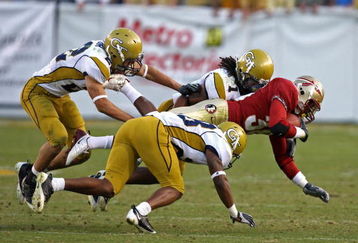 ATLANTA - NOVEMBER 1:  Members of the Georgia Tech Yellow Jackets defense, including safety Morgan Burnett #1, swarm running back Jermaine Thomas #38 of the Florida State Seminoles during the game at Bobby Dodd Stadium at Historic Grant Field on November 1, 2008 in Atlanta, Georgia.  The Yellow Jackets beat the Seminoles 31-28.  (Photo by Mike Zarrilli/Getty Images)