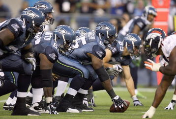 SEATTLE - AUGUST 22:  Center Chris Spencer #65 of the Seattle Seahawks gets ready to hike the ball during the game against the Denver Broncos on August 22, 2009 at Qwest Field in Seattle, Washington. (Photo by Otto Greule Jr/Getty Images)  