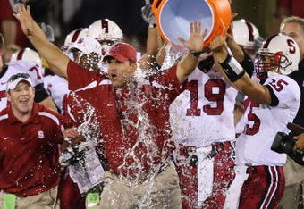 LOS ANGELES - OCTOBER 6:  Alex Loukas #15 celebrates with head coach Jim Harbaugh of the Stanford University Cardinal after defeating the USC Trojans 24-23 at the Los Angeles Memorial Coliseum October 6, 2007 in Los Angeles, California.  (Photo by Lisa Blumenfeld/Getty Images)