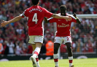 LONDON - APRIL 26:  Cesc Fabregas of Arsenal celebrates with his team mate Emmanuel Eboue after Fabregas scored the second goal during the Barclays Premier League match between Arsenal and Middlesbrough at Emirates Stadium on April 26, 2009 in London, England.  (Photo by Hamish Blair/Getty Images)