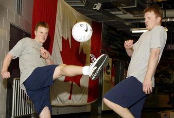 23 APR 2002: Twin brothers Henrik (Left) and Daniel Sedin of the Vancouver Canucks kick a soccer ball as they warm up before game four of the NHL Western Conference Quarterfinals against the Detroit Red Wings at General Motors Place in Vancouver, Canada.  DIGITAL IMAGE  Mandatory Credit:  Jeff Vinnick/Getty Images/NHLI