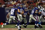 EAST RUTHERFORD, NJ - AUGUST 17:  Eli Manning #10 of the New York Giants throws a pass against the Carolina Panthers to teammate Mario Manningham #82 on August 17, 2009 at Giants Stadium in East Rutherford, New Jersey. The Giants defeated the Panthers 24-17.  (Photo by Jim McIsaac/Getty Images)