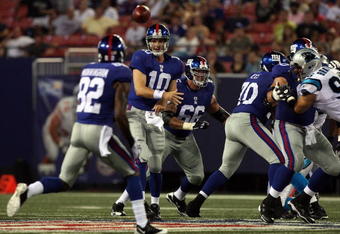 EAST RUTHERFORD, NJ - AUGUST 17:  Eli Manning #10 of the New York Giants throws a pass against the Carolina Panthers to teammate Mario Manningham #82 on August 17, 2009 at Giants Stadium in East Rutherford, New Jersey. The Giants defeated the Panthers 24-17.  (Photo by Jim McIsaac/Getty Images)