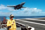 394815 02: An Arresting Gear Officer evaluates conditions September 21, 2001 as an F-14 'Tomcat' makes its approach during an arrested landing on the flight deck of the USS Theodore Roosevelt. The Roosevelt battle group departed from homeports in the United States September 19. (U.S. Navy Photo by Robert McRill/Getty Images)