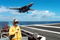 394815 02: An Arresting Gear Officer evaluates conditions September 21, 2001 as an F-14 'Tomcat' makes its approach during an arrested landing on the flight deck of the USS Theodore Roosevelt. The Roosevelt battle group departed from homeports in the United States September 19. (U.S. Navy Photo by Robert McRill/Getty Images)
