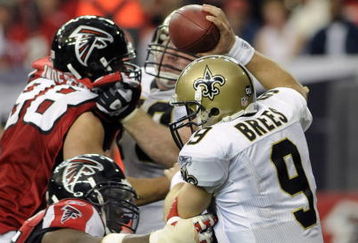 ATLANTA - NOVEMBER 9: Quarterback Drew Brees #9 of the New Orleans Saints dodges the pass rush of the Atlanta Falcons at the Georgia Dome on November 9, 2008 in Atlanta, Georgia.  (Photo by Al Messerschmidt/Getty Images)