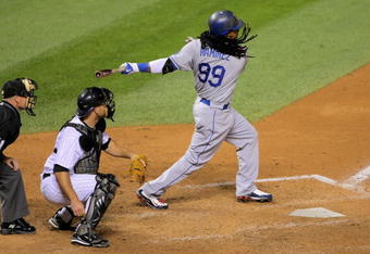 DENVER - AUGUST 25:  Manny Ramirez #99 of the Los Angeles Dodgers singles to right field to score Rafael Furcal, tying the score 4-4 in the ninth inning against the Colorado Rockies at Coors Field on August 25, 2009 in Denver, Colorado. The Rockies defeated the Dodgers 5-4 in 10 innings.  (Photo by Doug Pensinger/Getty Images)