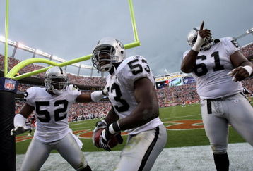 DENVER - SEPTEMBER 16:  Thomas Howard #53 of the Oakland Raiders celebrates his interception for a touchdown with Kirk Morrison #52 and Gerard Warren #61 against the Denver Broncos as the Broncos defeated the Raiders 23-20 in overtime during week two NFL action at Invesco Field at Mile High on September 16, 2007 in Denver, Colorado.  (Photo by Doug Pensinger/Getty Images)
