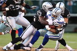 OAKLAND, CA - AUGUST 13:  Running back Marion Barber #24 of the Dallas Cowboys is tackled by Thomas Howard #53 and Ricky Brown #57 of the Oakland Raiders in the first quarter during the preseason game at Oakland-Alameda County Coliseum on August 13, 2009 in Oakland, California. (Photo by Jed Jacobsohn/Getty Images)