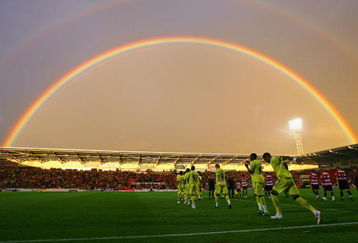 DONCASTER, ENGLAND - AUGUST 26:  Tottenham Hotspur and Doncaster Rovers players run on to the pitch as a rainbow arcs over Keepmoat Stadium before the Carling Cup second round match between Doncaster Rovers and Tottenham Hotspur on August 26, 2009 in Doncaster, England.  (Photo by Alex Livesey/Getty Images)