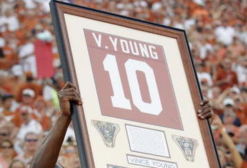 AUSTIN, TX - AUGUST 30:  Quarterback Vince Young of the Tennessee Titans, holds up his Texas Longhorns jersey as his number is retired before a game against the Florida Atlantic Owls at Darrell K Royal-Texas Memorial Stadium on August 30, 2007 in Austin, Texas.  (Photo by Brian Bahr/Getty Images)