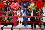 LAS VEGAS - AUGUST 24:  (L-R) Wrestler Triple H, an Elvis Presley impersonator, World Wrestling Entertainment Inc. Chairman Vince McMahon and wrestler Shawn Michaels appear in the ring with showgirls during McMahon's 64th birthday celebration during the WWE Monday Night Raw show at the Thomas & Mack Center August 24, 2009 in Las Vegas, Nevada.  (Photo by Ethan Miller/Getty Images)