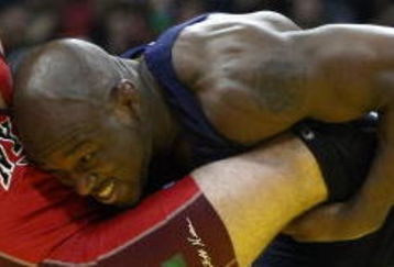 LAS VEGAS - JUNE 15:  Andy Hrvot (red) is thrown by Mo Lawal (blue) in the Freestyle 84kg division championship match during the USA Olympic trials for wrestling and judo on June 15, 2008 at the Thomas & Mack Center in Las Vegas, Neveda.  (Photo by Jonathan Ferrey/Getty Images)