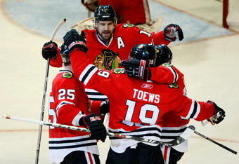 CHICAGO - MAY 24:  (L-R) Cam Barker #25, Patrick Sharp #10, Jonathan Toews #19 and Patrick Kane #88 of the Chicago Blackhawks celebrate after Toews scored a goal in the second period against the Detroit Red Wings during Game Four of the Western Conference Championship Round of the 2009 Stanley Cup Playoffs on May 24, 2009 at the United Center in Chicago, Illinois.  (Photo by Jim Prisching/Getty Images)
