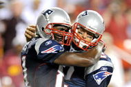 LANDOVER, MD - AUGUST 28:  Tom Brady #12 and Randy Moss #81 of the New England Patriots celebrate after scoring a touchdown in the second quarter of a preseason game against the Washington Redskins at FedExField on August 28, 2009 in Landover, Maryland.  (Photo by Greg Fiume/Getty Images)