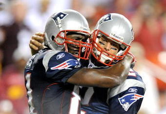 LANDOVER, MD - AUGUST 28:  Tom Brady #12 and Randy Moss #81 of the New England Patriots celebrate after scoring a touchdown in the second quarter of a preseason game against the Washington Redskins at FedExField on August 28, 2009 in Landover, Maryland.  (Photo by Greg Fiume/Getty Images)