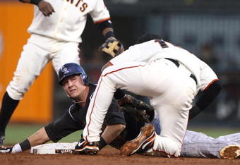 SAN FRANCISCO - AUGUST 28: Troy Tulowitizki #2 of the Colorado Rockies is tagged out on a steal attempt by Edgar Renteria #16 of the San Francisco Giants in the second inning during a Major League Baseball game at AT&T Park on August 28, 2009 in San Francisco, California.  (Photo by Jed Jacobsohn/Getty Images)