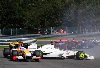 SPA FRANCORCHAMPS, BELGIUM - AUGUST 30:  Romain Grosjean (L) of France and Renault and Jenson Button (R) of Great Britain and Brawn GP collide at Les Combes corner on the first lap of the Belgian Grand Prix at the Circuit of Spa Francorchamps on August 30, 2009 in Spa Francorchamps, Belgium.  (Photo by Clive Mason/Getty Images)