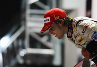 SINGAPORE - SEPTEMBER 28:  Fernando Alonso of Spain and Renault celebrates on the podium after winning the Singapore Formula One Grand Prix at the Marina Bay Street Circuit on September 28, 2008 in Singapore.  The event is the first Formula One race to be held at night.  (Photo by Clive Mason/Getty Images)