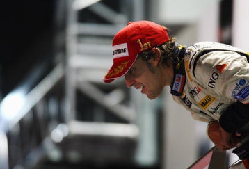 SINGAPORE - SEPTEMBER 28:  Fernando Alonso of Spain and Renault celebrates on the podium after winning the Singapore Formula One Grand Prix at the Marina Bay Street Circuit on September 28, 2008 in Singapore.  The event is the first Formula One race to be held at night.  (Photo by Clive Mason/Getty Images)