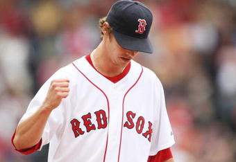 BOSTON - AUGUST 13:  Starting pitcher Clay Buchholz #61 of the Boston Red Sox reacts to the out during the game against the Detroit Tigers at Fenway Park on August 13, 2009 in Boston, Massachusetts. (Photo by Elsa/Getty Images)